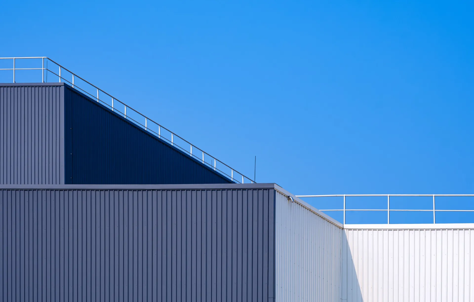 gray-and-white-corrugated-factory-building-with-st-2025-03-11-03-40-46-utc_1920